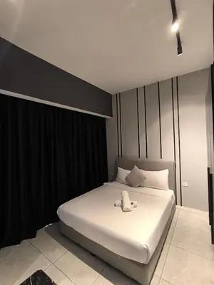 a bedroom with a white bed with black curtains at The Bukit Bintang Near pavilion Axon Residence KL in Kuala Lumpur