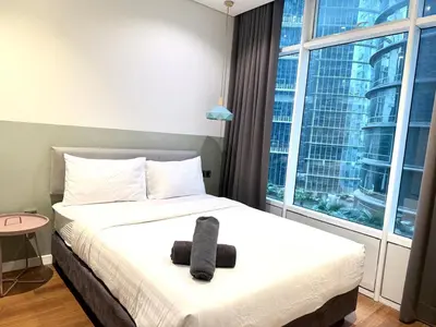 a bedroom with a bed with a black towel on it at sky suites klcc by Natasya in Kuala Lumpur