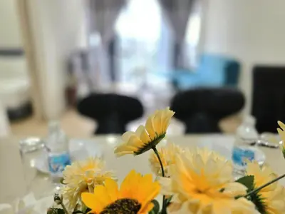 a table with yellow flowers on top of it at A1 Hospitality At Star Residence KLCC in Kuala Lumpur
