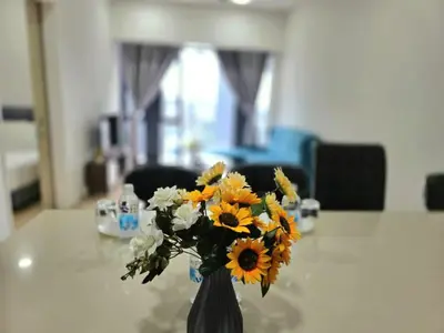 a vase filled with flowers sitting on a table at A1 Hospitality At Star Residence KLCC in Kuala Lumpur