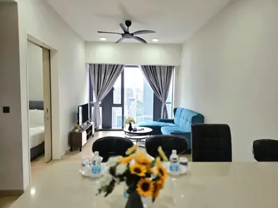 a living room with a table and a blue couch at A1 Hospitality At Star Residence KLCC in Kuala Lumpur
