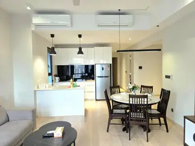 a kitchen and living room with a table and chairs at A1 Hospitality At Star Residence KLCC in Kuala Lumpur