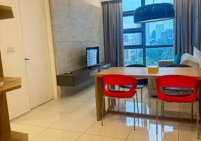 a dining room with a table and red chairs at Robertson By Sahara Urban Oasis in Kuala Lumpur
