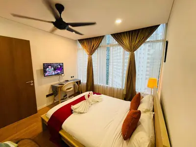 a bedroom with a bed with a ceiling fan at Vortex Suites klcc \u975e\u5e38\u8212\u9002\u7684\u4f4f\u5bbf in Kuala Lumpur
