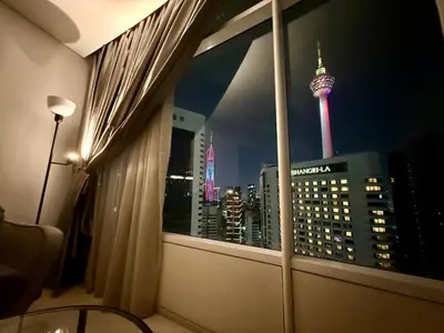 a room with a window with a view of the msg tower at Vortex Suites klcc \u975e\u5e38\u8212\u9002\u7684\u4f4f\u5bbf in Kuala Lumpur