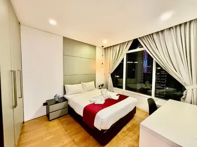 a bedroom with a bed and a large window at Vortex Suites klcc \u975e\u5e38\u8212\u9002\u7684\u4f4f\u5bbf in Kuala Lumpur