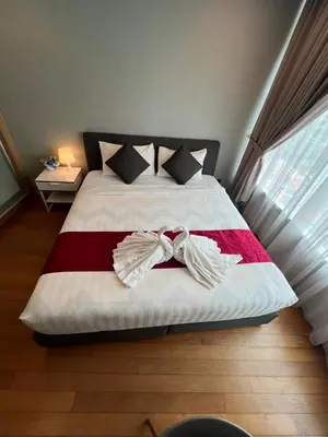 a bedroom with a bed with a bow tie on it at Vortex Suites klcc \u975e\u5e38\u8212\u9002\u7684\u4f4f\u5bbf in Kuala Lumpur