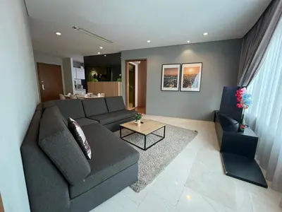 a living room with a gray couch and a table at Vortex Suites klcc \u975e\u5e38\u8212\u9002\u7684\u4f4f\u5bbf in Kuala Lumpur
