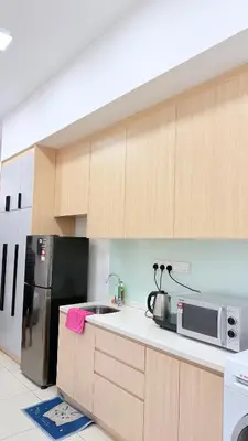 a kitchen with a refrigerator and a microwave at Colony Luxe By Swift Homes in Kuala Lumpur
