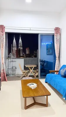 a living room with a bed and a table at Colony Luxe By Swift Homes in Kuala Lumpur