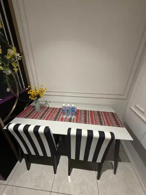 a table with two glasses on top of it at Aurora by comfort in Kuala Lumpur