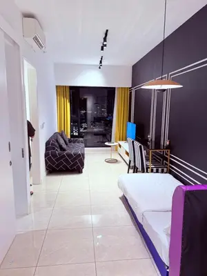 a living room with a bed and a couch at Aurora by comfort in Kuala Lumpur