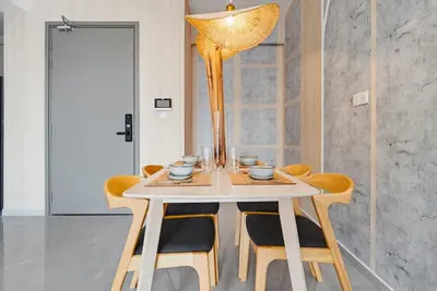 a dining room with a table with chairs and a chandelier at Earthy 2BR @ Agile BB | Wi-Fi + Netflix in Kuala Lumpur