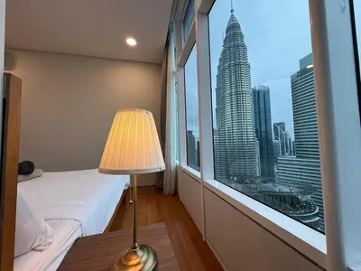 a bedroom with a bed and a window with a view at Sky Suits By White Houze in Kuala Lumpur
