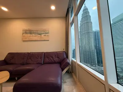 a living room with a couch and a large window at Sky Suits By White Houze in Kuala Lumpur