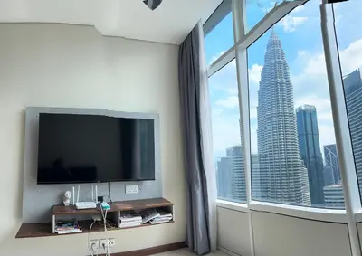 a living room with a tv and a large window at Sky Suits By White Houze in Kuala Lumpur