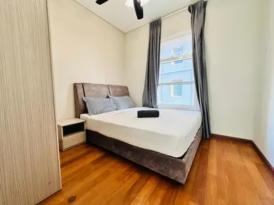 a bedroom with a large bed and a window at Sky Suits By White Houze in Kuala Lumpur