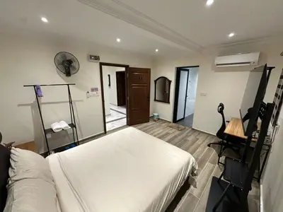 a bedroom with a bed and a desk in a room at My Kamar Kamar in Kuala Lumpur
