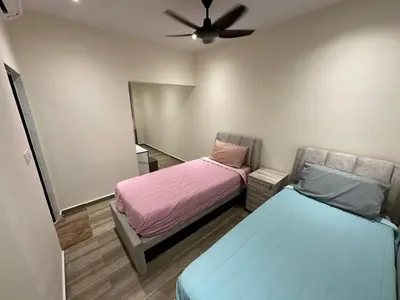 a bedroom with two beds and a ceiling fan at My Kamar Kamar in Kuala Lumpur