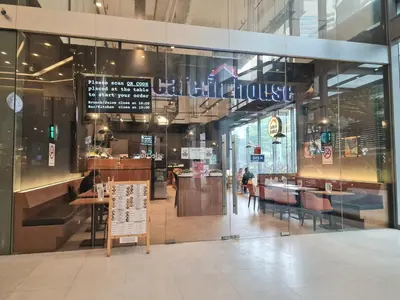 a restaurant with a sign in the middle of a building at Summer suites klcc by Amna in Kuala Lumpur