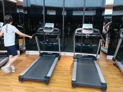 a woman walking on a treadmill in a gym at B&B at TRION KL in Kuala Lumpur