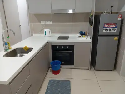 a small kitchen with a sink and a refrigerator at B&B at TRION KL in Kuala Lumpur