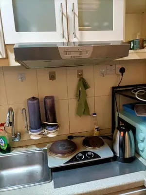 a kitchen with a sink and a stove top oven at Cozy Suite City Central in Kuala Lumpur