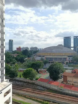 a view of a city with a building in the background at Cozy Suite City Central in Kuala Lumpur