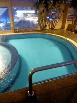 a jacuzzi tub in a hotel at night at Cozy Suite City Central in Kuala Lumpur