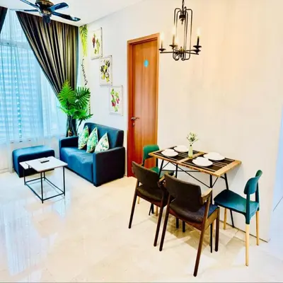a living room with a table and a blue couch at sky suites klcc by Sweet home Apartment in Kuala Lumpur