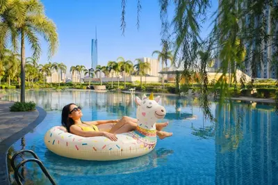 a woman riding an inflatable unicorn in a pool at Trion Kuala Lumpur in Kuala Lumpur