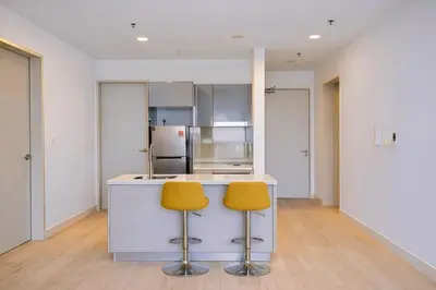 a kitchen with two yellow chairs at a counter at Trion Kuala Lumpur in Kuala Lumpur