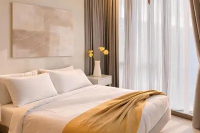 a bedroom with a bed and a vase with flowers at Trion Kuala Lumpur in Kuala Lumpur