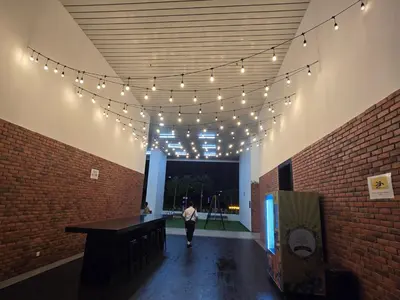 a person walking down a hallway with string lights at KLCC SERVICED Suites CHAMBERS in Kuala Lumpur