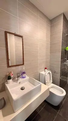 a bathroom with a white sink and a toilet at Trion sky suite KL in Kuala Lumpur