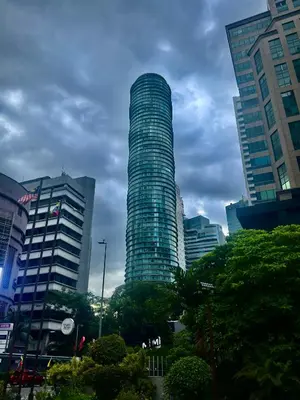 a tall skyscraper in the middle of a city at Vortex Suites Apartment Klcc in Kuala Lumpur