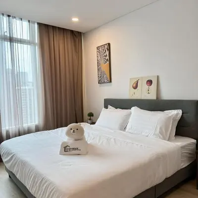 a bed with a hello kitty pillow on top of it at 30 OFF Monthly l Premium 3BR Suite in KLCC in Kuala Lumpur