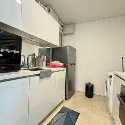 a kitchen with white cabinets and a refrigerator at 30 OFF Monthly l Premium 3BR Suite in KLCC in Kuala Lumpur