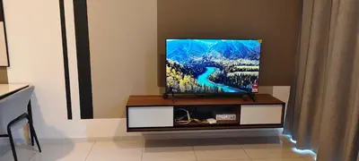 a flat screen tv on a stand in a room at Majestic Residence Klcc By DIVINA in Kuala Lumpur