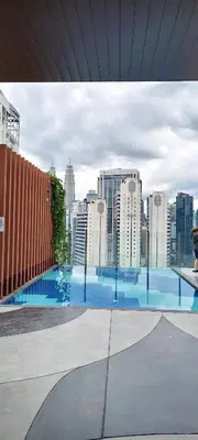 a large swimming pool with a view of a city at Majestic Residence Klcc By DIVINA in Kuala Lumpur