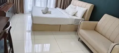 a bedroom with a bed and a couch and a chair at Majestic Residence Klcc By DIVINA in Kuala Lumpur