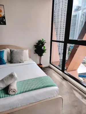 a bedroom with a bed and a large window at Scarletz Suites KLCC by cozy stay in Kuala Lumpur
