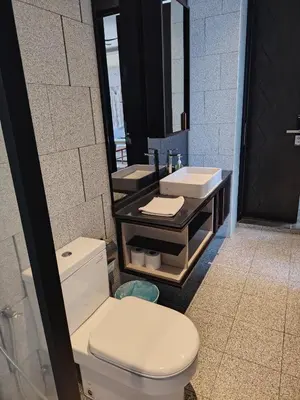 a bathroom with a white toilet and a sink at Scarletz Suites KLCC by cozy stay in Kuala Lumpur