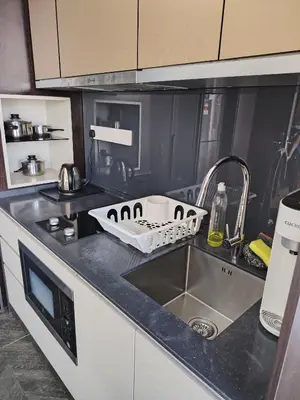 a kitchen counter top with a sink and a sink at Scarletz Suites KLCC by cozy stay in Kuala Lumpur