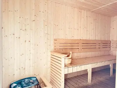 a wooden bench in a sauna with a bucket at Majestic Suites klcc By Falak in Kuala Lumpur