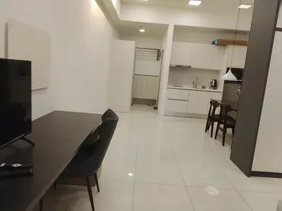 a kitchen and dining room with a table and chairs at Kuala Lumpur Chambers Suites KLCC in Kuala Lumpur