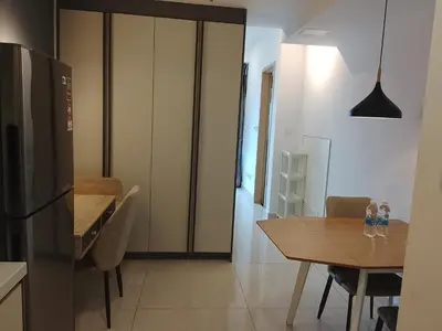 a kitchen and dining room with a table and a refrigerator at The Luxe Suites Colony Sky Pools in Kuala Lumpur