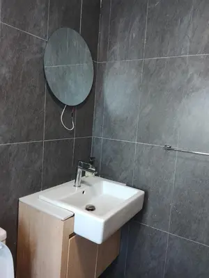 a bathroom with a sink and a mirror at The Luxe Suites Colony Sky Pools in Kuala Lumpur