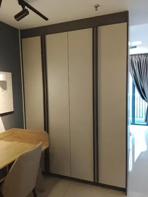 a sliding closet door in a room with a table at The Luxe Suites Colony Sky Pools in Kuala Lumpur