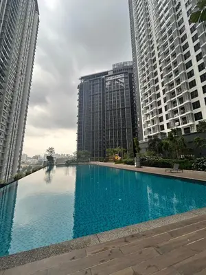a large swimming pool in the middle of two tall buildings at Affordable and welcoming home inside the city limits in Kuala Lumpur